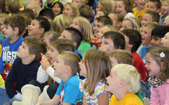 children engaged and laughing during the best environment show for schools